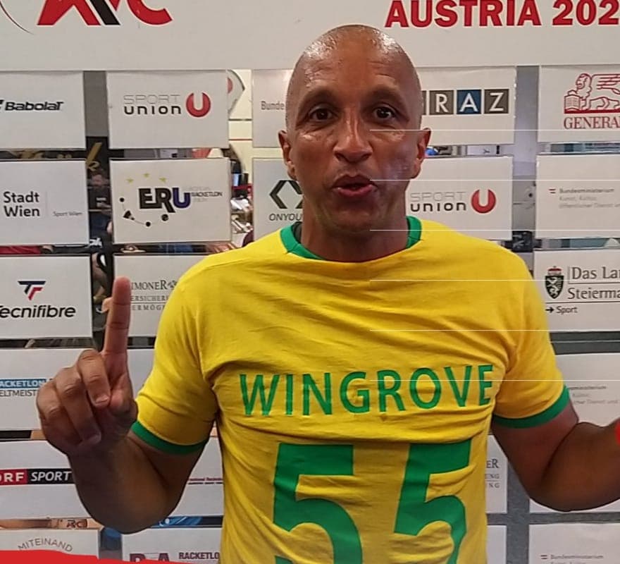 Jermaine Manners at the 2022 Racketlon World Championships in Austria, in a yellow and green shirt reading Wingrove 55
